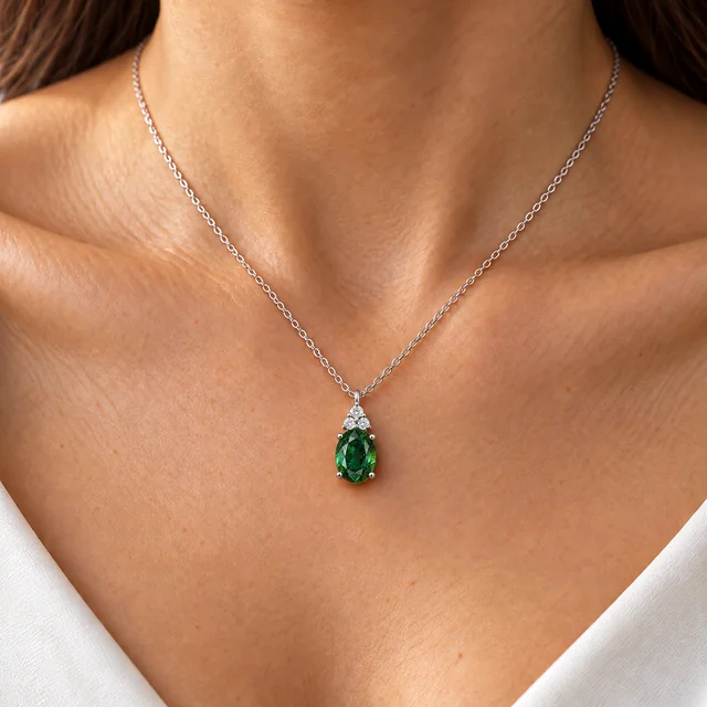 Sunflower Premium Chic Emerald Pendant worn at the collarbone against an ivory background