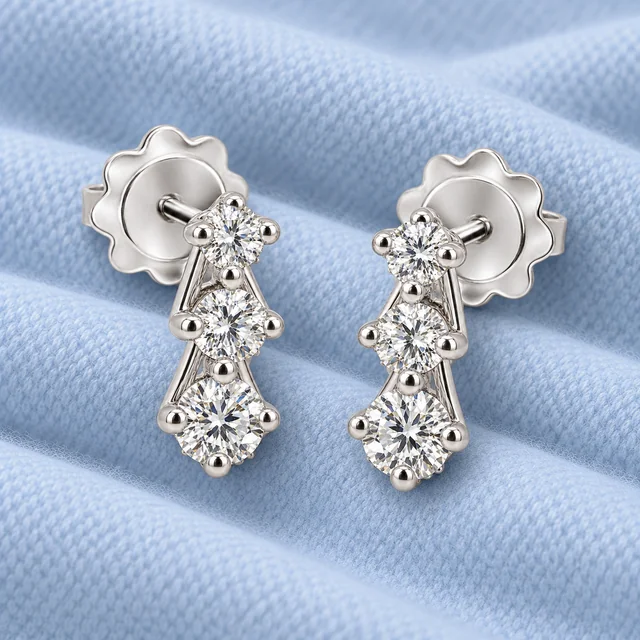 Trilogy Scalare Flower Earrings on softly folded pale ice-blue cashmere