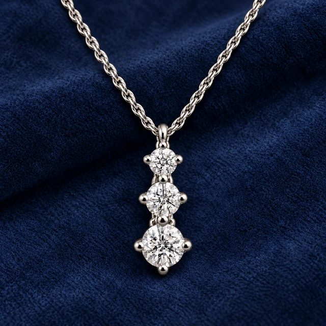 The Three-Stone Pendant on navy blue suede